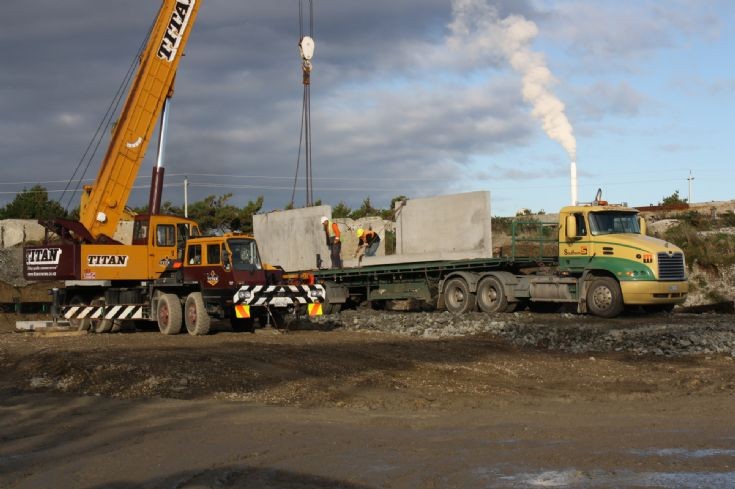Mack Vision unloading concrete retainer walls at South-Wood Export, Awarua