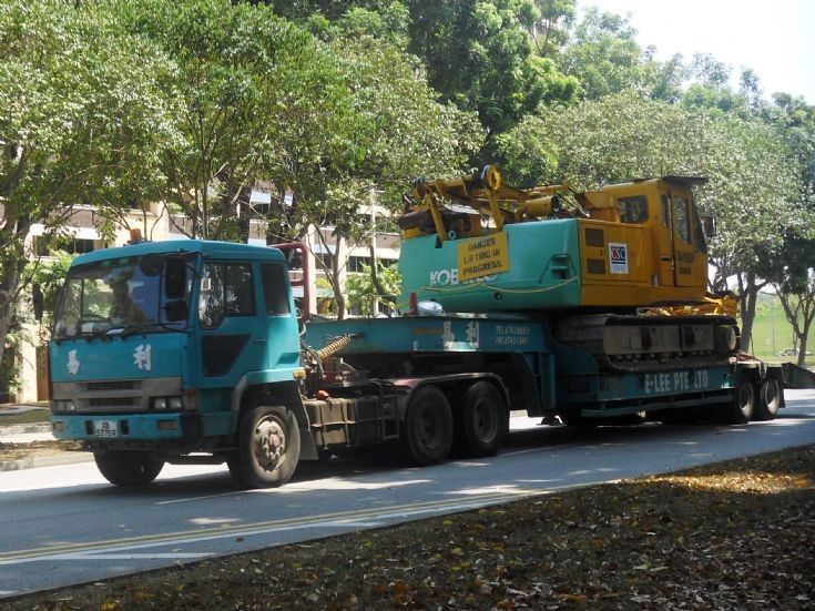 E-Lee Pte Ltd Mitsubishi Fuso Great FP411DR Tractor hauling a low loader trailer with a crawler crane