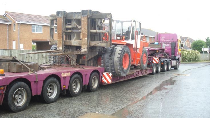 Huge lowloader with a fork truck