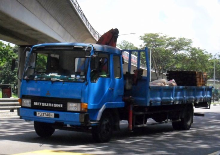 This medium duty old Mitsubishi Fuso Fighter FK457 cargo cum dump truck 