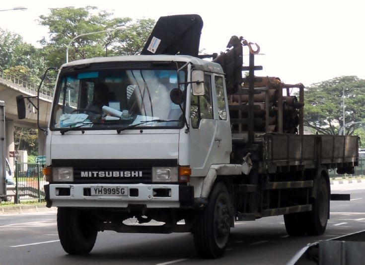 This medium duty old Mitsubishi Fuso Fighter FM517 cargo truck which comes 